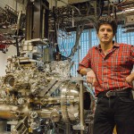 Dr. Damascelli stands beside the experimental apparatus used to test his superconductivity theories. Photo credit: Hogan Wong