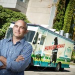John Butt stands outside of the first food truck on campus, The Hungry Nomad. Photo credit: Martin Dee